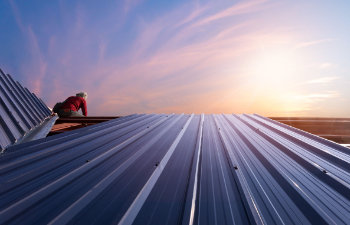 construction worker installing new roof